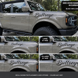 May include: A black vinyl side hood name decal in cursive script reading Bullseye, displayed on a tan SUV. The image shows four size options: medium 12 inches wide, large 16 inches wide, extra-large 20 inches wide, and 24 inches wide.