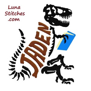 May include: An embroidered design featuring a dinosaur skeleton reading a book. The name "Jaden" is incorporated into the dinosaur's body in brown letters. The book is blue with yellow pages. The Luna Stitches .com logo is in the upper left corner.