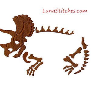 May include: Brown embroidered design of a dinosaur skeleton, with the text "LunaStitches.com" in red at the top.
