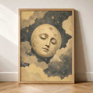 May include: A framed wall art print featuring a personified moon with a serene facial expression, surrounded by soft, textured clouds in shades of cream and dark blue. Small, golden six-pointed stars are scattered throughout the night sky.