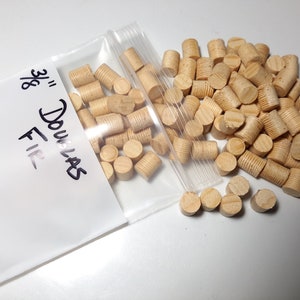 May include: A bag of 3/8 inch dowels made of Douglas Fir wood. The dowels are tapered and have a natural wood color.