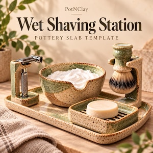 May include: A ceramic wet shaving station set with a speckled green and beige glaze. The set includes a rectangular tray, a shaving bowl with white lather, a soap dish with a round soap bar, and two stands for a metal razor and brush.