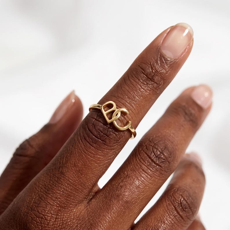 Create a truly personal statement piece with this custom two letter ring, designed to showcase two initials, a monogram, or your own custom logo in a timeless solid gold design. Whether you want to represent two meaningful initials, a couple's letters, a family monogram or your personal brand, this personalized initial ring transforms your idea into a unique piece of jewelry.
