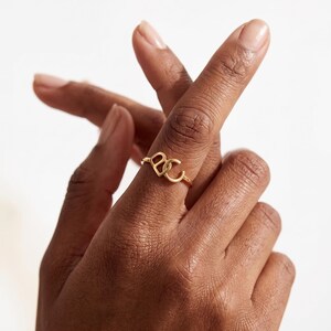 Create a truly personal statement piece with this custom two letter ring, designed to showcase two initials, a monogram, or your own custom logo in a timeless solid gold design. Whether you want to represent two meaningful initials, a couple's letters, a family monogram or your personal brand, this personalized initial ring transforms your idea into a unique piece of jewelry.
