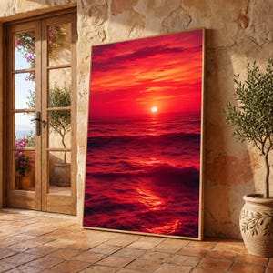 Peut inclure: Une impression d'art mural rectangulaire représentant un coucher de soleil vibrant sur l'océan. La scène montre un soleil brillant centré à l'horizon, projetant des teintes rouge vif et orange dans le ciel et se reflétant sur les vagues.