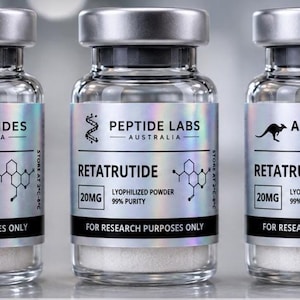 May include: Three clear glass vials with silver caps, each containing white lyophilised powder. The labels are silver and holographic, featuring the text Retatrutide, 20mg, 99% purity, and for research purposes only, with brand names Pro Peptides, Peptide Labs, and Aus Peptides.