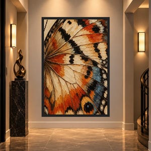 May include: A rectangular wall art piece featuring a close-up, detailed illustration of a butterfly wing. The wing displays a vibrant color palette of orange, black, white, and blue, with intricate vein patterns and a prominent circular eyespot.