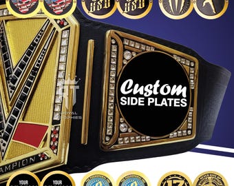 May include: A black leather championship belt featuring a large gold center plate with black and red accents and clear crystals. The side plate displays the text Custom SIDE PLATES. Multiple circular gold and black logo inserts are shown.