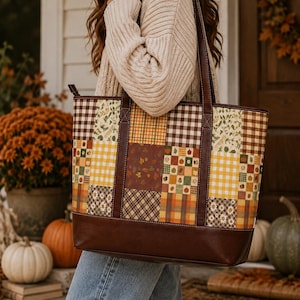 May include: A large tote bag featuring a patchwork design with various autumn-themed patterns including brown and white gingham, yellow plaid, and floral prints. The bag has a solid dark brown leather-like base and matching dark brown shoulder straps.