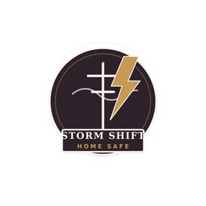May include: A circular sticker featuring a dark purple background with a white utility pole graphic, a gold lightning bolt, and a wavy line. Below the graphic, a rectangular label displays the text STORM SHIFT in white and HOME SAFE in gold.