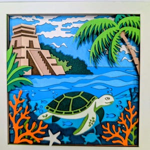 May include: A multi-layered wooden wall art piece featuring a sea turtle swimming in blue water with orange coral and a white starfish in the foreground. The background depicts a beige stepped pyramid structure, green foliage, and a palm tree.