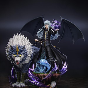 May include: A detailed anime-style figurine featuring a silver-haired character with black wings holding a purple orb, standing beside a large wolf with white fur and a golden horn. A blue slime creature sits at the base, surrounded by purple energy effects.