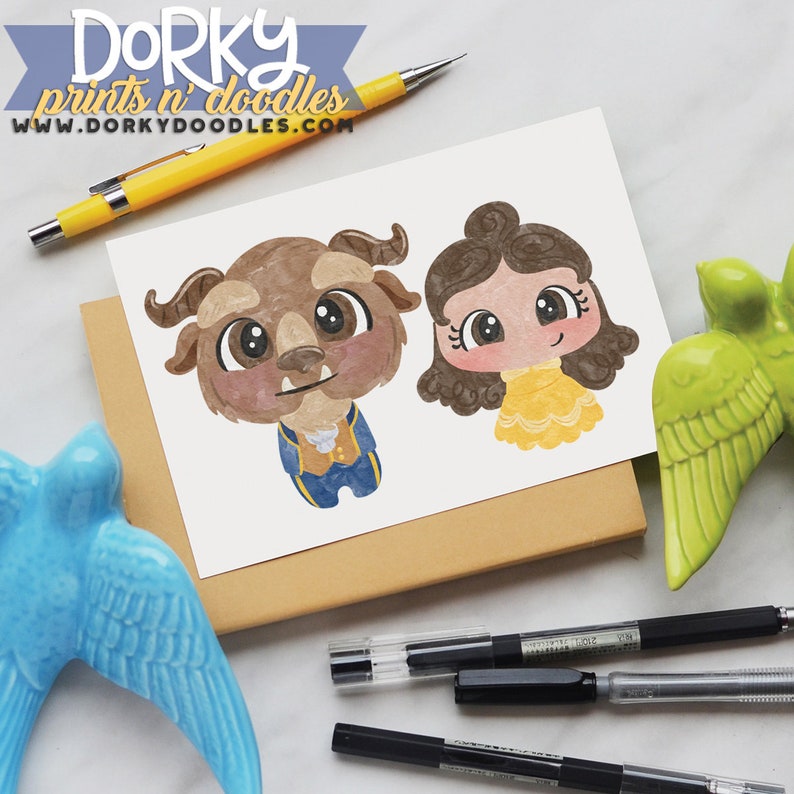 May include: A printable illustration of Belle and the Beast from Disney's Beauty and the Beast. The characters are drawn in a cartoon style with large eyes and are colored in shades of brown, yellow, and blue. The illustration is on a white background.