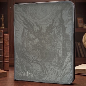 May include: A gray rectangular trading card binder featuring a detailed embossed illustration of a winged creature soaring above a gothic castle under a crescent moon. The brand name vaultx is printed in the bottom left corner of the cover.