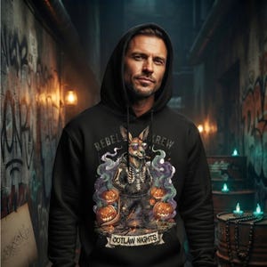 May include: A black hooded sweatshirt featuring a graphic print of a kangaroo wearing sunglasses and a skeleton-patterned hoodie. The design includes pumpkins, purple smoke, and the text REBEL KREW and OUTLAW NIGHTS printed on the front chest area.