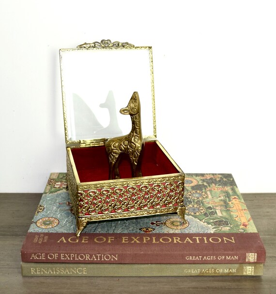 Vintage gilt ormolu jewelry box with a glass lid..