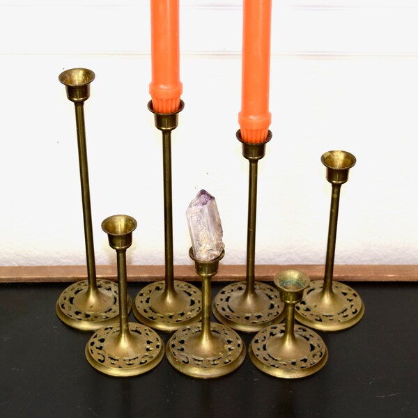 Vintage graduated brass candle holders…graduated brass candlestick holders...set of 7...openwork base...
