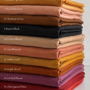 May include: A stack of folded fabric swatches in various colors labeled 6 Golden Apricot, 7 Peach Blossom, 8 Chestnut Grove, 9 Raven Black, 10 Prairie Wheat, 11 Clay Blossom, 12 Amber Leaf, 13 Maple Wood, 14 Orchid Bloom, 15 Cherrywood Wine, 16 Pomegranate.