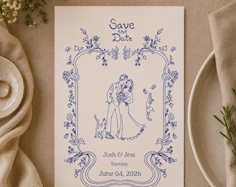 May include: A rectangular white Save the Date card featuring blue line art of a couple and two cats inside a floral border. The text reads Save the Date, Josh & Jess, Tuesday, June 04, 2026. The design includes intricate vines and flowers.