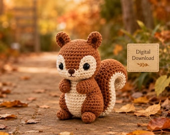 May include: A brown and cream-colored crocheted squirrel toy with large black eyes and a bushy tail. A rectangular tan label with the text Digital Download is positioned to the right of the squirrel, featuring a small leaf graphic below the text.