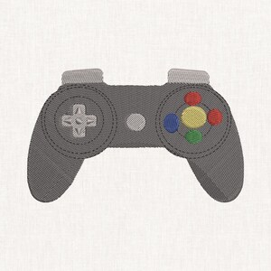 May include: A grey embroidered video game controller patch featuring a light grey directional pad on the left, a central light grey circular button, and four coloured action buttons on the right in red, yellow, blue, and green.