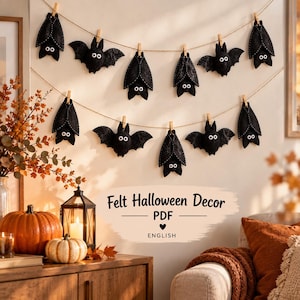 May include: A garland of black felt bats with white eyes, suspended by wooden clothespins on a string. The text reads Felt Halloween Decor PDF ENGLISH. The bats are displayed in two rows, with some hanging wings down and others with wings spread wide.