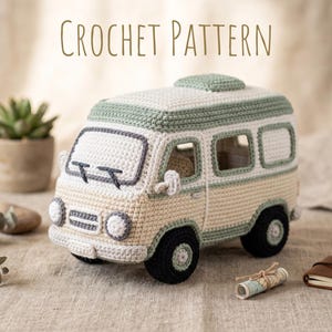 May include: A crochet pattern for a toy van in cream, sage green, and black yarn. The van features a cream body, sage green roof and trim, black wheels, and a windshield with wipers. The text CROCHET PATTERN is displayed above the toy.