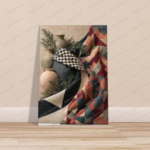May include: A rectangular canvas print featuring a still life composition of three ceramic vases in shades of tan and black, partially draped with a textured quilt displaying a geometric pattern in red, blue, and cream colors with green foliage.