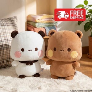 May include: Two plush toys featuring rounded bodies and small ears. The left toy is white with dark brown ears, a dark brown neck accessory, and pink cheeks. The right toy is light brown with dark brown ears and yellow cheeks. Both have simple faces.