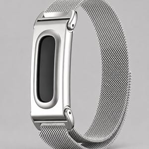 May include: A silver-colored fitness tracker replacement band featuring a metallic mesh strap and a smooth, rectangular frame with a black, oval-shaped center display area. The design includes integrated lugs that connect the frame to the strap.