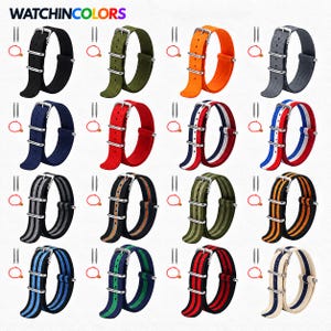 May include: A collection of sixteen nylon watch straps in various solid colors and striped patterns, each featuring a silver-tone metal buckle and two keepers. The text WATCHINCOLORS is at the top left, with two spring bars and a tool included.