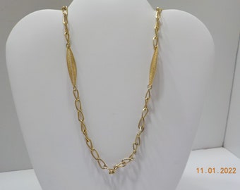 May include: A gold chain necklace with two decorative, oval-shaped pendants.