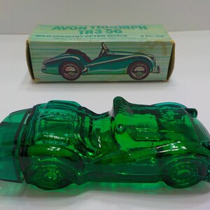 May include: Green glass bottle shaped like a vintage car, Avon Triumph TR3 56 Wild Country After Shave 2 fl oz.
