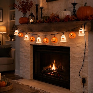 May include: A string of Halloween lights featuring alternating translucent white ghost figures and orange jack-o'-lanterns with carved facial expressions. The decorative light strand is connected by a black wire and plugged into a wall outlet.