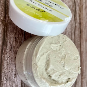 May include: A white jar with a green and yellow label that reads "French Green Clay Sea Kelp Cream Face Wash Be Youthful #201067". The jar is filled with a light green face mask.