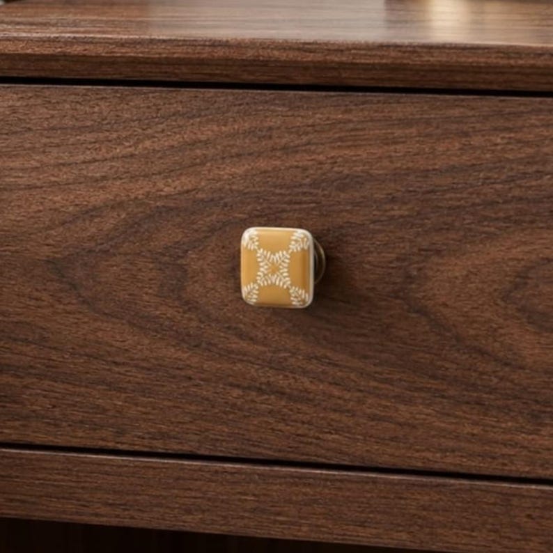 Yellow ceramic cabinet knob, square boho tile drawer pull with white hand-painted pattern for furniture upcycling, dressers, and nightstands.