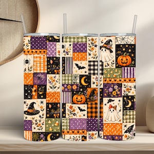May include: Three cylindrical tumblers with straws, each featuring a patchwork design of Halloween-themed squares. Patterns include black cats, ghosts, pumpkins, bats, spiders, moons, stars, flowers, and plaid in orange, purple, black, and white.