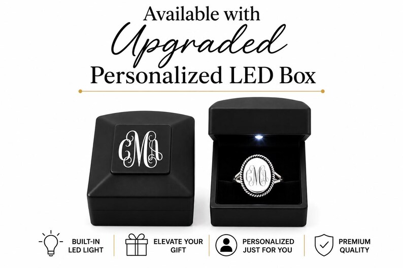Puede incluir: Una caja de anillo negra con un monograma personalizado en la tapa y una caja abierta que contiene un anillo ovalado plateado con un monograma a juego. El texto dice Available with Upgraded Personalized LED Box, Built-in LED Light, Elevate Your Gift, Personalized Just For You y Premium Quality.