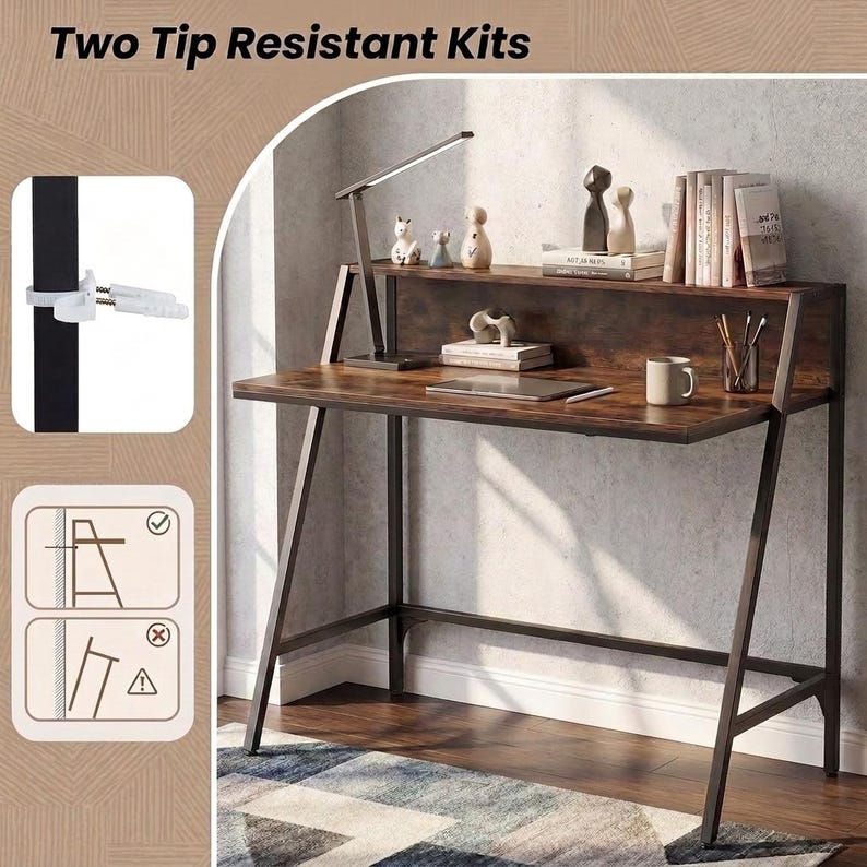 May include: A dark wood desk with a black metal frame, featuring a raised shelf, a slim desk lamp, and two tip resistant kits shown in an inset. The kits include white plastic wall anchors and straps to secure the desk to a wall for stability.