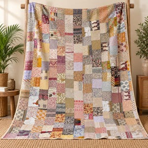 May include: A large rectangular quilt constructed from numerous vertical strips of fabric, each featuring a distinct pattern and color palette. The textile displays a variety of floral, geometric, and abstract prints in shades of yellow, pink, blue, and brown.