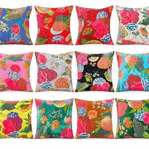 May include: A collection of twelve square throw pillows featuring vibrant, multi-colored floral patterns and intricate kantha stitching. Each pillow displays a unique combination of bright hues including red, blue, pink, green, and yellow.