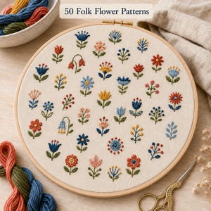 May include: A round wooden embroidery hoop containing off-white fabric with 50 Folk Flower Patterns embroidered in various colours including blue, red, yellow, and green. The hoop is accompanied by colourful embroidery floss and gold scissors.