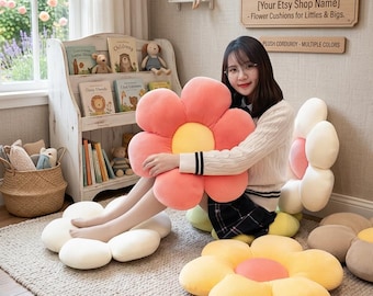 May include: A collection of plush flower-shaped floor cushions made from corduroy fabric. The cushions feature large rounded petals in various colors including coral, yellow, and white, with a contrasting circular center on each flower.