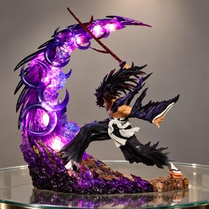 May include: A dynamic anime-style action figure depicting a character with dark hair in a combat stance, wielding a thin red sword. A large, glowing purple crescent-shaped energy effect surrounds the figure, illuminated by integrated LED lights.
