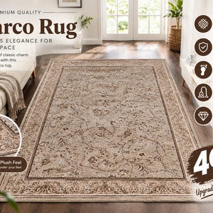 May include: A rectangular Marco Rug featuring a beige base with intricate brown floral and vine patterns. The rug has a wide decorative border with detailed scrollwork and a soft, plush texture. The design includes a central field of foliage.
