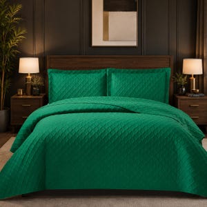 May include: A vibrant emerald green bedspread set featuring a quilted diamond pattern. The set includes a large coverlet that drapes over the bed and two matching rectangular pillow shams, all showcasing a consistent textured geometric design.
