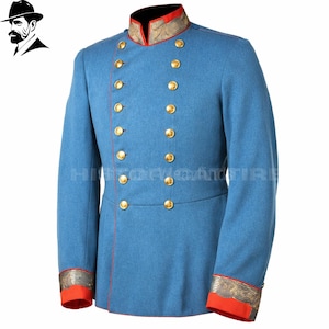 May include: A light blue double-breasted jacket featuring a high collar with red trim, gold-toned buttons, and red cuffs with metallic embroidery. The garment includes a vertical red piping detail along the front closure and structured shoulders.