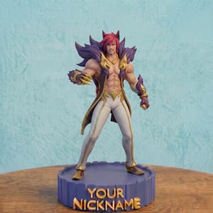 May include: A collectible figurine of a muscular character with spiky pink hair, purple fur-like collar, and gold accents, wearing white pants. The figure stands on a circular purple base with the gold text YOUR NICKNAME embossed on the front.