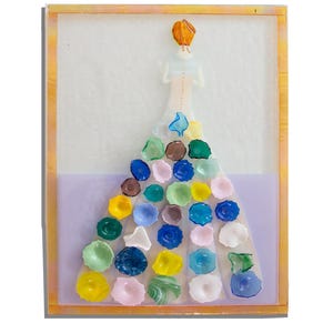 May include: A rectangular wall art piece featuring a stylized figure with orange hair viewed from behind. The figure wears a long gown adorned with numerous small, colorful, translucent glass flower-like shapes in shades of blue, green, yellow, and pink.