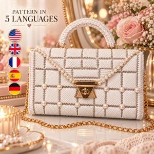 May include: A white rectangular handbag featuring a textured grid pattern, a crocheted top handle, and a gold-tone metal clasp. The bag is adorned with small white pearls along the front flap and includes a gold-tone chain shoulder strap.